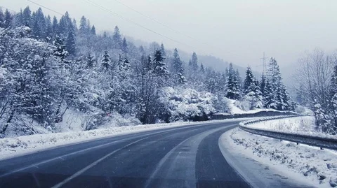 Driving on the winter forest road in heavy snowfall, beautiful landscape Stock Footage 120418132