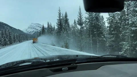 Driving on winter road behind plow truck, POV 4k Video stock 256363907