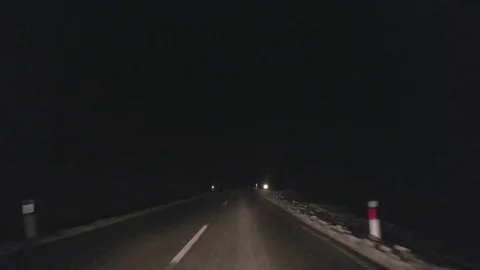 Driving on the winter road at night Stock Footage
