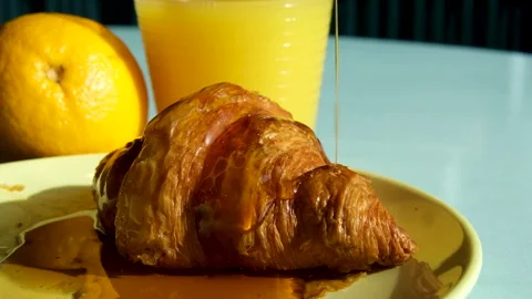 Drizzle maple syrup over croissant baking is poured with maple syrup video Stock Footage 292129375