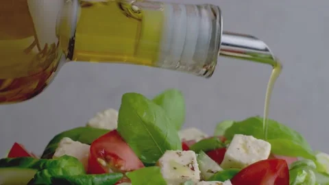 Drizzle of olive oil on fresh healthy salad Stock Footage