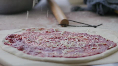 Drizzling cheese on a pizza Stock Footage 285557401