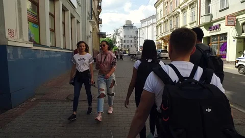 DROGOBYCH, UKRAINE - 3 MAY, 2019: Group of tourists with backpacks walking Video stock 108849541