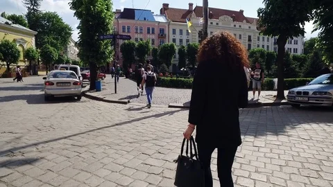 DROGOBYCH, UKRAINE - 3 MAY, 2019: Back shot of young woman in suit. Girl walking Video stock 108851030