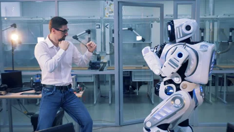A droid and a man fighting in a room. Stock Footage 91211568