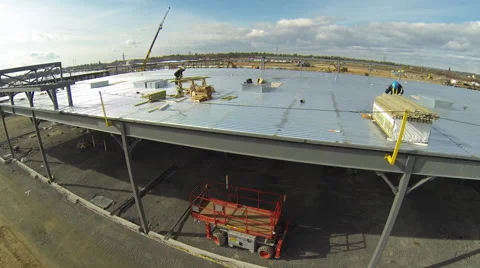 Drome flying over the metal frame of a building in construction Stock Footage 63936609