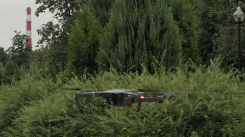 The dron is flying around himself in the summer garden Stock Footage 77627427