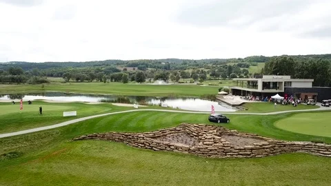 A dron shot of a tesla on a golf field Stock Footage 115992852
