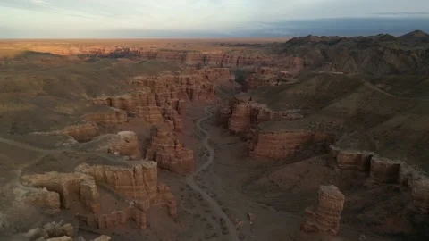 Dron shot top view of the charyn canyon with a mountain landscape behind Stock Footage 227124687