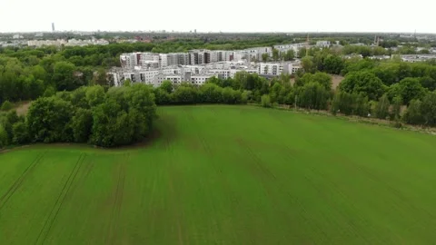 Dron shot of wheat field and housing estate in the suburbs in Europe 動画素材 154206644