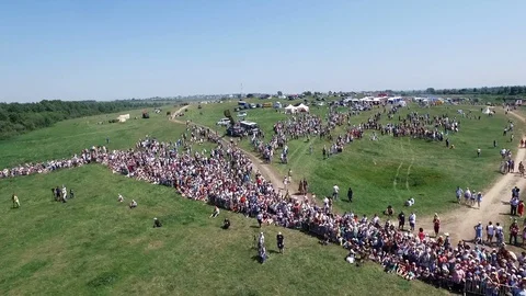 Dron top view many crowded people on open field modern celebration in suny day Stock Footage 119664846