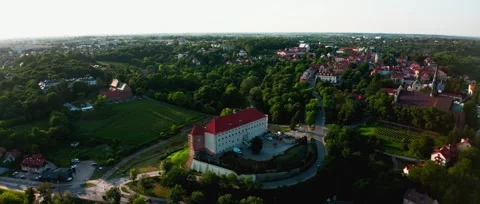 Dron view of Sandomierz Castle on a hill with red roofs and green parkland Stock Footage 319556528