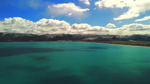 Drone 180 degree rotation over Bear Lake Utah with turquoise water Stock Footage 335080790