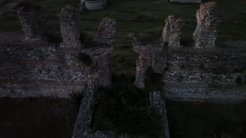 Drone 360 degree orbit shot flying around the ancient Nicopolis walls at dusk Stock Footage 345168259