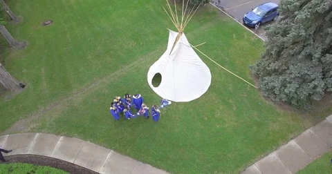 Drone 4k Aerial Video new grads toss caps in air graduation Stock Footage 79238564