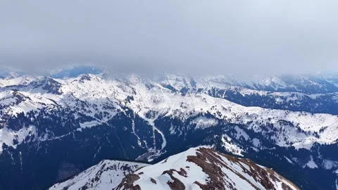 Drone 4K backward flight over snowy Alps mountain ridge Stock Footage 334237845