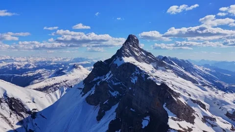 Drone 4K flight toward snowy alpine peak in Haute-Savoie Stock Footage 334434543