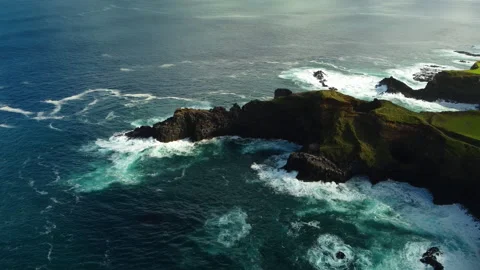 Drone 4K flying left-to-right over cliff tip with grass and crashing waves Stock Footage 315248701