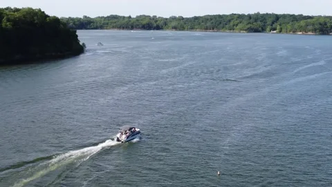 Drone 4k footage flying over boats on a lake and following Stock Footage 159434841