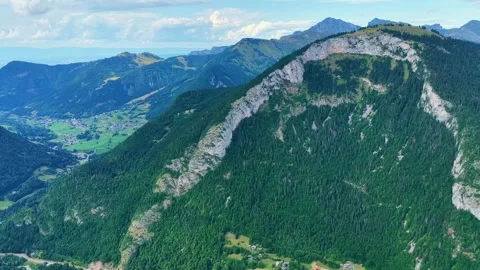 Drone 4K Forward Flight Over Forested Alpine Cliff and Valley Stock Footage 331633719