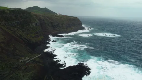 Drone 4K over cliff with rough sea and crashing waves Stock Footage 315254620