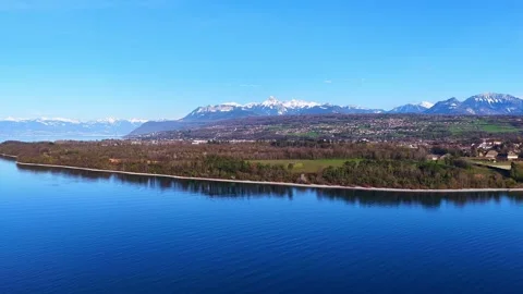Drone 4K Pullback Lake Leman Shore Village Alps Stock Footage 332152729