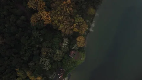 Drone 4K top-down over gothic chapel, lake, and surrounding forest Stock Footage 315255023