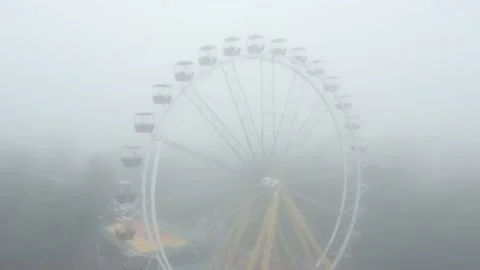 Drone 4k video ferris wheel in a city amusement park on a foggy morning Stock Footage 160789227