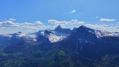 Drone 4K view toward snowy alpine peaks in Haute-Savoie Stock Footage 334337406