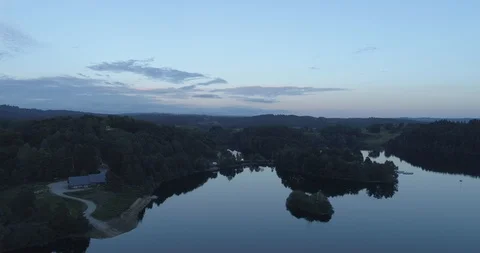 Drone above a lake surrounded by forest Stock Footage 125997069