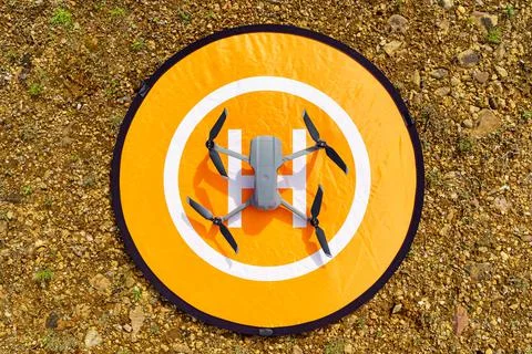 Drone above the runway before flying in an upper zenith shot. Stock Photos