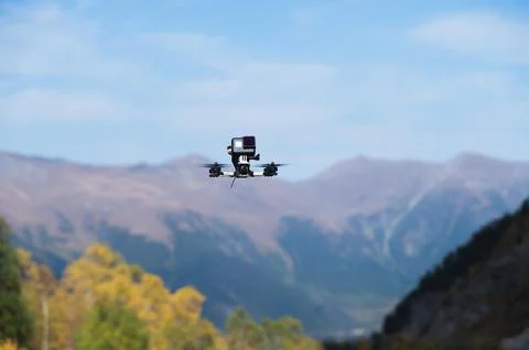 Drone with an action camera films mountains in flight. close-up of an unmanned Stock Photos