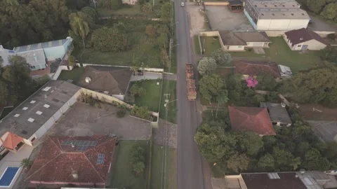 Drone active tracking shot of logging truck driving through residential nei.. Stock Footage 335526591