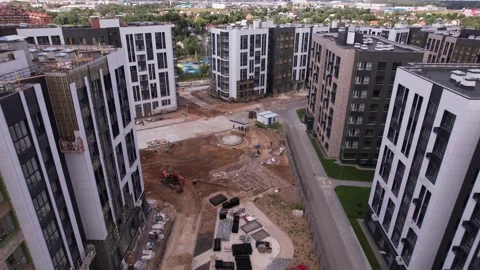 Drone advancing and pitching down over construction Vidéo 330015558