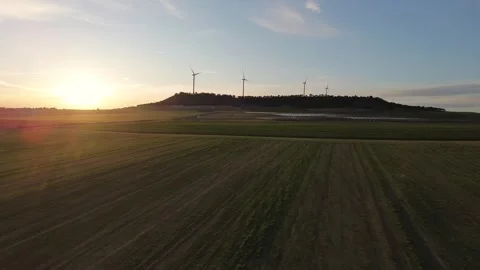 Drone Advancing Over Green Cereal Field Toward Solar Farm and Wind Turbines Stock Footage 330051280