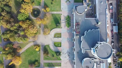 Drone advancing over park and building complex Stock Footage 323874196