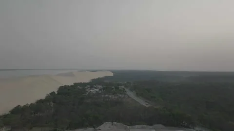 Drone advancing toward camping with dune left and forest right, France Stock Footage 333108180