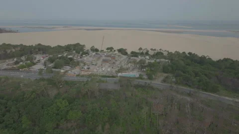 Drone advancing toward dune with forest foreground, France Stock Footage 333108278