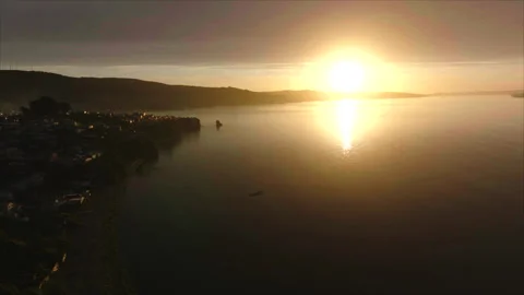 Drone advancing toward ocean sunset with coast left Stock Footage 340991745