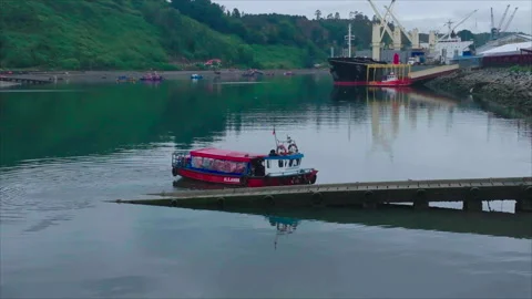 Drone advancing toward red boat to close-up Stockbeeldmateriaal 340991345