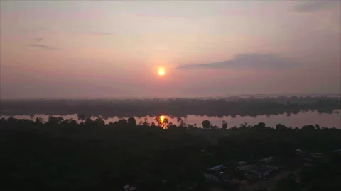 Drone advancing toward sunset with river and forest, Ouesso, Congo Stock Footage 331999723