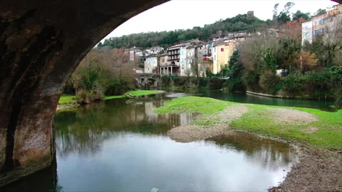Drone advancing under stone bridge arch Stockbeeldmateriaal 347585311