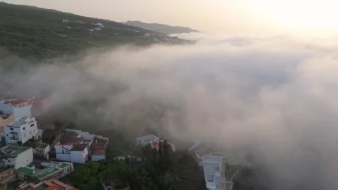 Drone Aerial 4K Flight Over Clouds with Mountain Peaks at Sunset – Scenic Stock Footage 314600752