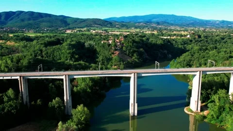 Drone aerial 4K view from above AGV ITALO Train passes by bridge Tuscany Italy Stock Footage 199836083