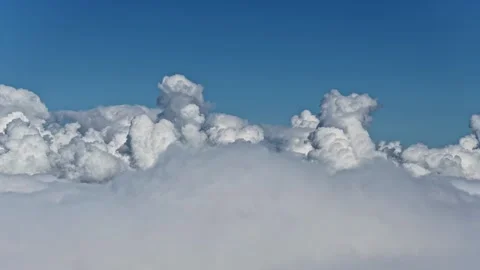 Drone aerial above fluffy clouds on a sunny day with endless sky and soft white Vídeos de archivo 332609088