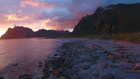 Drone Aerial of beautiful beach Uttakleiv Lofoten, Norway surrounded by mountain Stock Footage