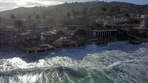 Drone aerial capture of huge waves crashing into beachfront restaurant San Diego Stock Footage 101576324