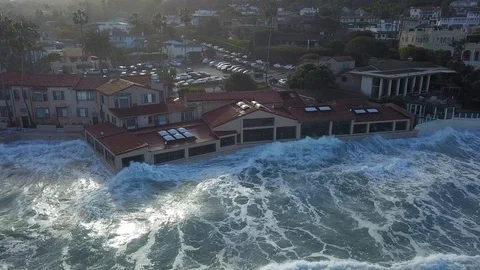 Drone aerial capture of huge waves crashing into beachfront restaurant San Diego Stock Footage 101577245
