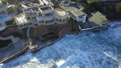 Drone aerial capture of huge waves crashing into beachfront restaurant San Diego Stock Footage 101577287