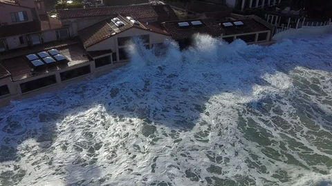 Drone aerial capture of huge waves crashing into beachfront restaurant San Diego Stock Footage 101577404